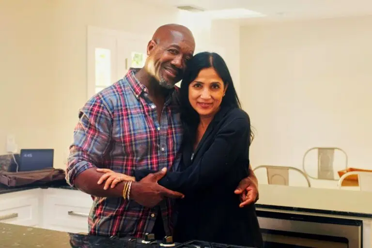 Smiling couple embracing in the kitchen of their new home