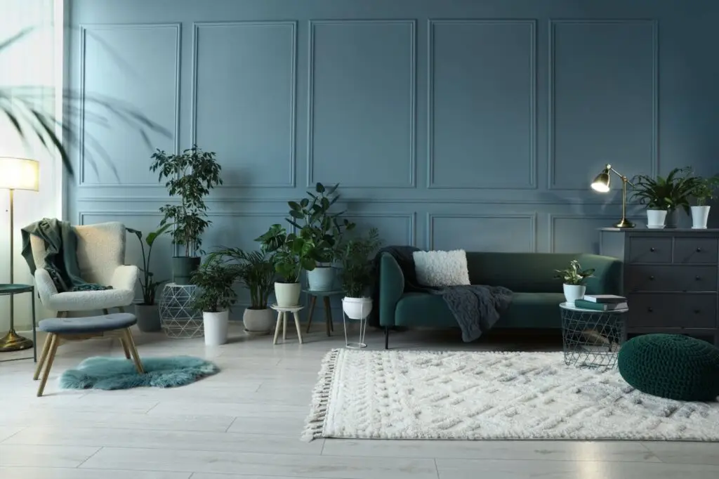 Stylish living room with a green sofa and plenty of house plants