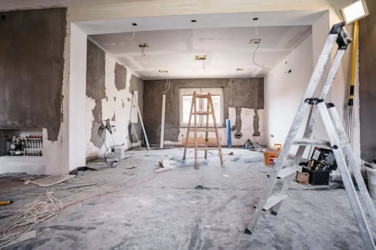 Room stripped back to bare walls with ladders ready for a renovation