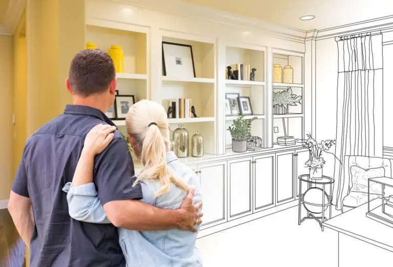 Couple embracing as they look at a half sketched wall of built in shelves
